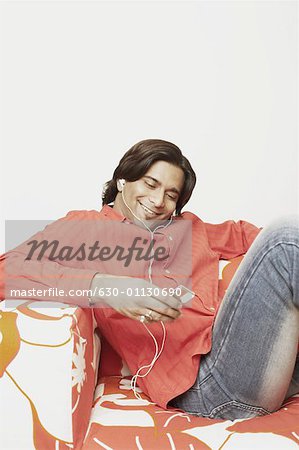 Young man listening to an MP3 player