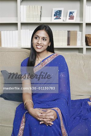 Close-up of a young woman sitting on a couch