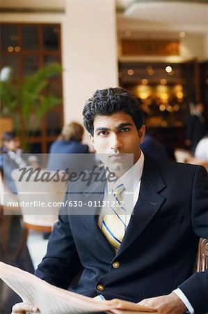 Portrait of a businessman holding a newspaper