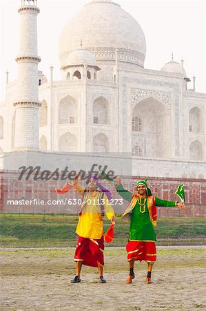 Two young men dancing in front of a mausoleum, Taj Mahal, Agra, Uttar Pradesh, India