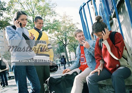 Young people hanging out together outside.