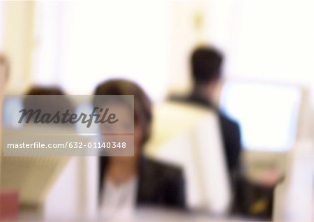 People working at computers in office, blurred