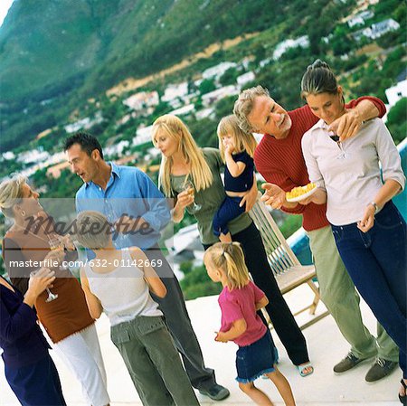 People standing and holding glasses, outside