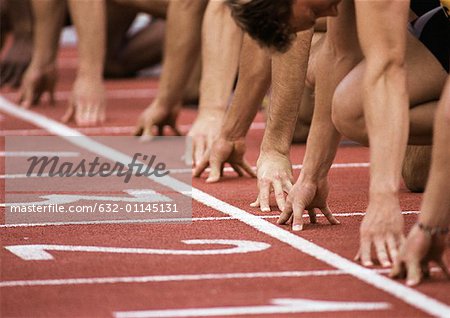 Male runners at starting line, low section, close-up