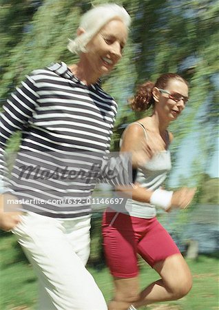 Two joggers in park