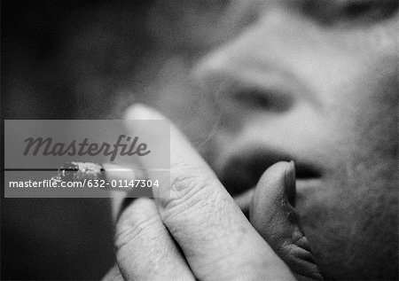 Person smoking cigarette, close-up, blurred, b&w