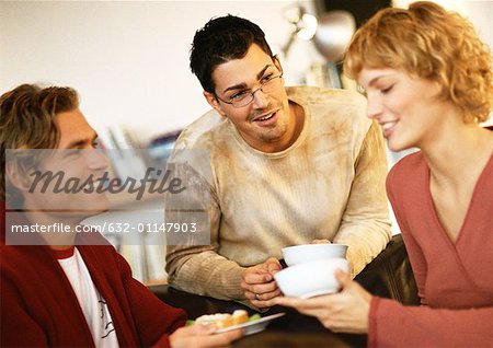 Young people holding dishes