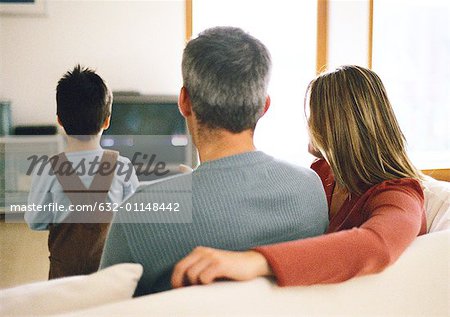 Family sitting together, watching TV