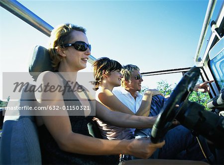 Two women and man in 4x4 vehicle