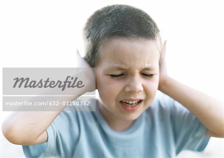 Boy with hands against ears, close-up