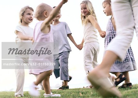 Children holding hands, walking in ring