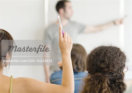 Female student raising hand in class