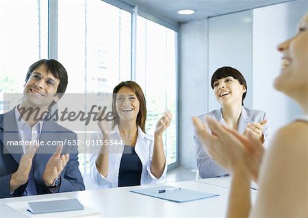 Business team clapping in meeting