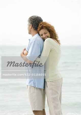 Mature couple, woman hugging man from behind