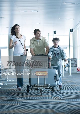 Family hurrying through airport