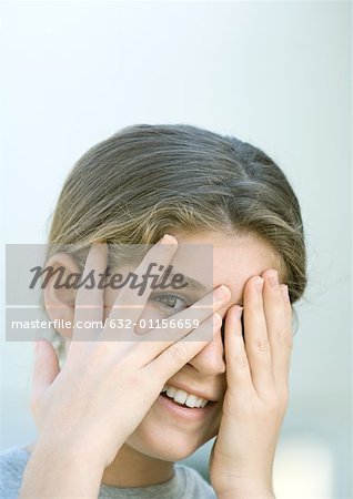 Preteen girl covering face