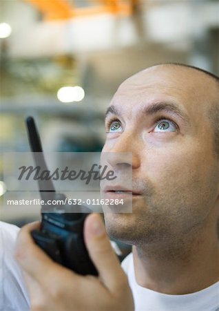 Factory worker using walkie talkie