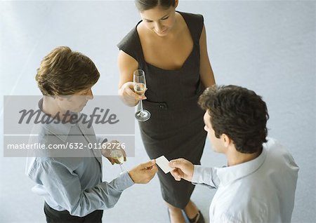 Executives exchanging business card during cocktail party