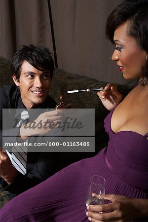 Man Lighting Woman's Cigarette