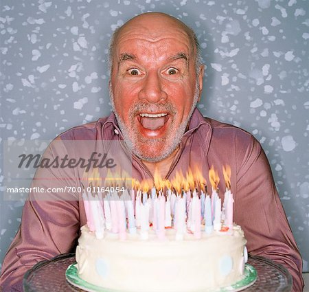 Homme Avec Gateau D Anniversaire Photographie De Stock Masterfile Rights Managed Artiste Masterfile Code 700