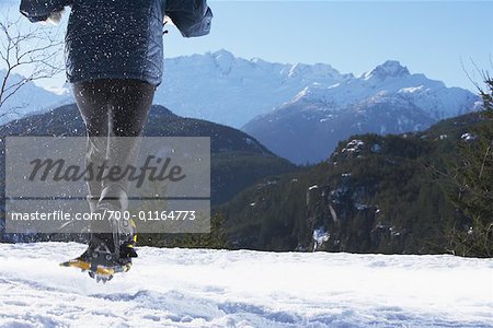 Woman Running with Snowshoes