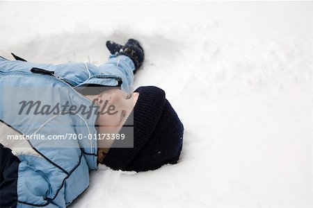 Boy Lying in Snow