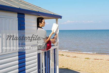 Man Reading at Beach House
