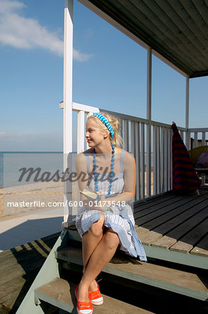 Woman Sitting on Porch with Book