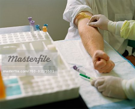 Doctor Taking Blood Sample from Man's Arm