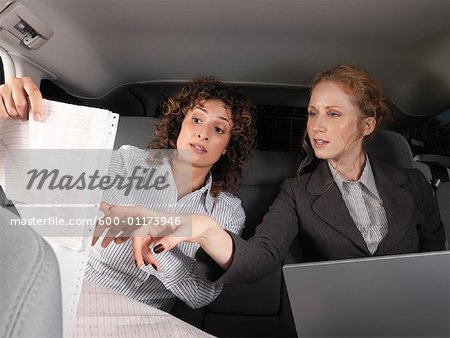 Businesswomen Working in Back of Car
