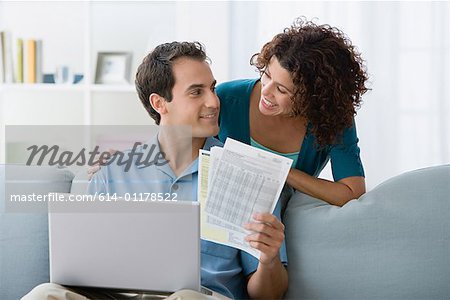 Couple looking at home finances on computer