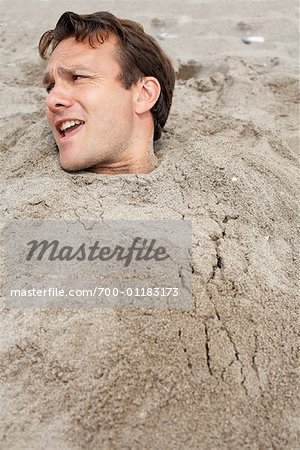 Man Buried in Sand at Beach