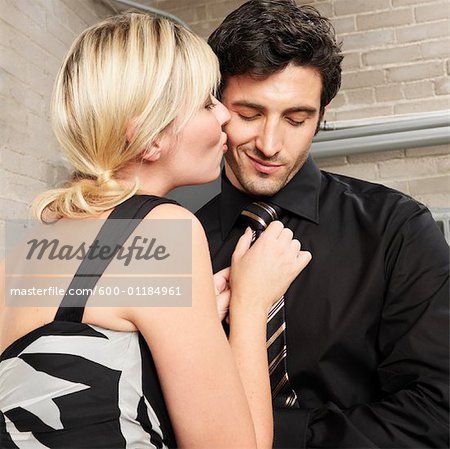 Woman Adjusting Man's Tie