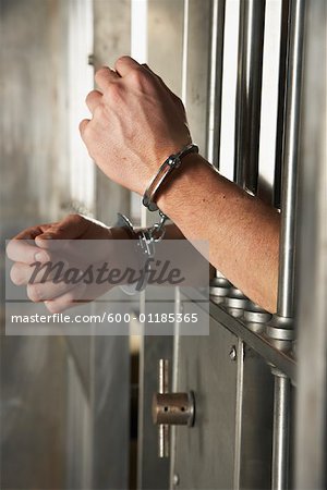 Man Handcuffed to Cell Door