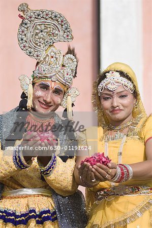 Portrait of two performers holding rose petals at an elephant festival, Jaipur, Rajasthan, India