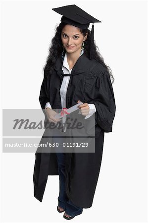 Portrait of a young woman holding a diploma and smiling