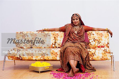 Portrait of a bride sitting on a couch