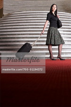 Woman with Luggage in Hotel Foyer