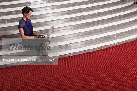 Woman on Staircase with Laptop Computer