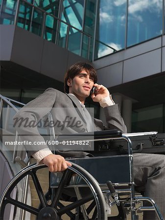 Man in Wheelchair Talking on Cellular Phone