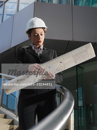 Businesswoman Looking at Plans