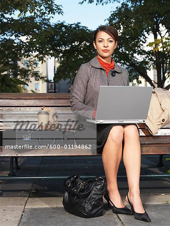 Woman on Park Bench Using Laptop Computer