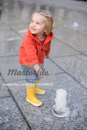 Girl Playing in Fountain