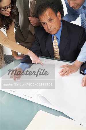 Business People Looking at Blueprints