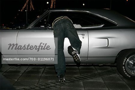 Man Reaching Into Car