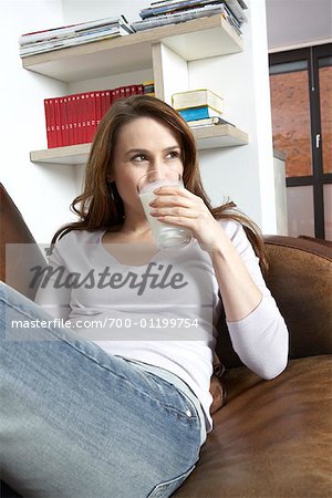 Woman Drinking Milk on Sofa