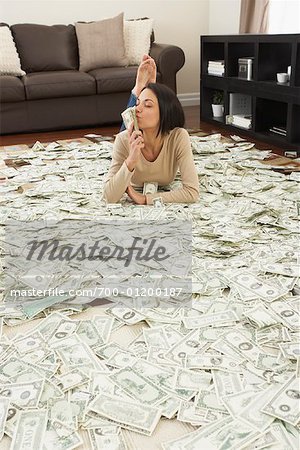 Woman at Home with Pile of Money