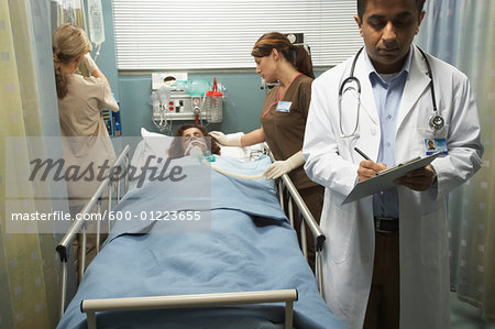 Doctor and Nurses Tending to Patient