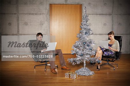 Couple at Home with Christmas Tree