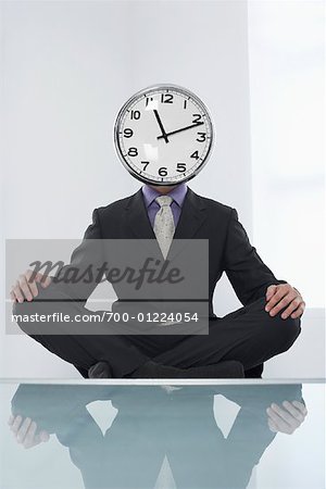 Businessman with Clock Face Meditating